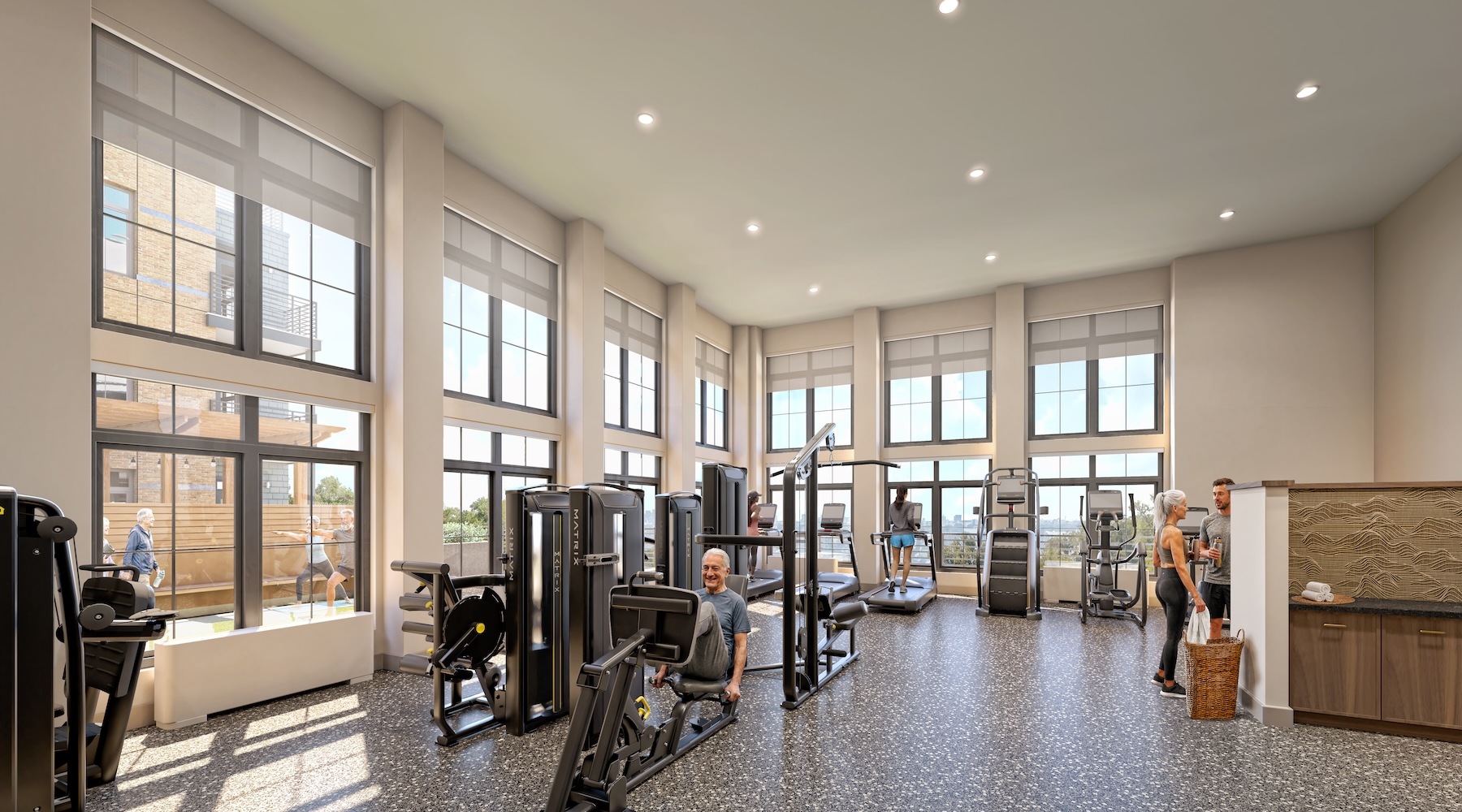 a gym with exercise equipment and people working out